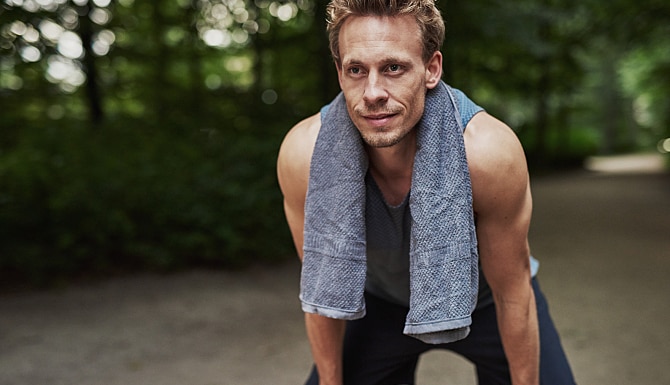 Athletic Man Resting After Jogging At The Park